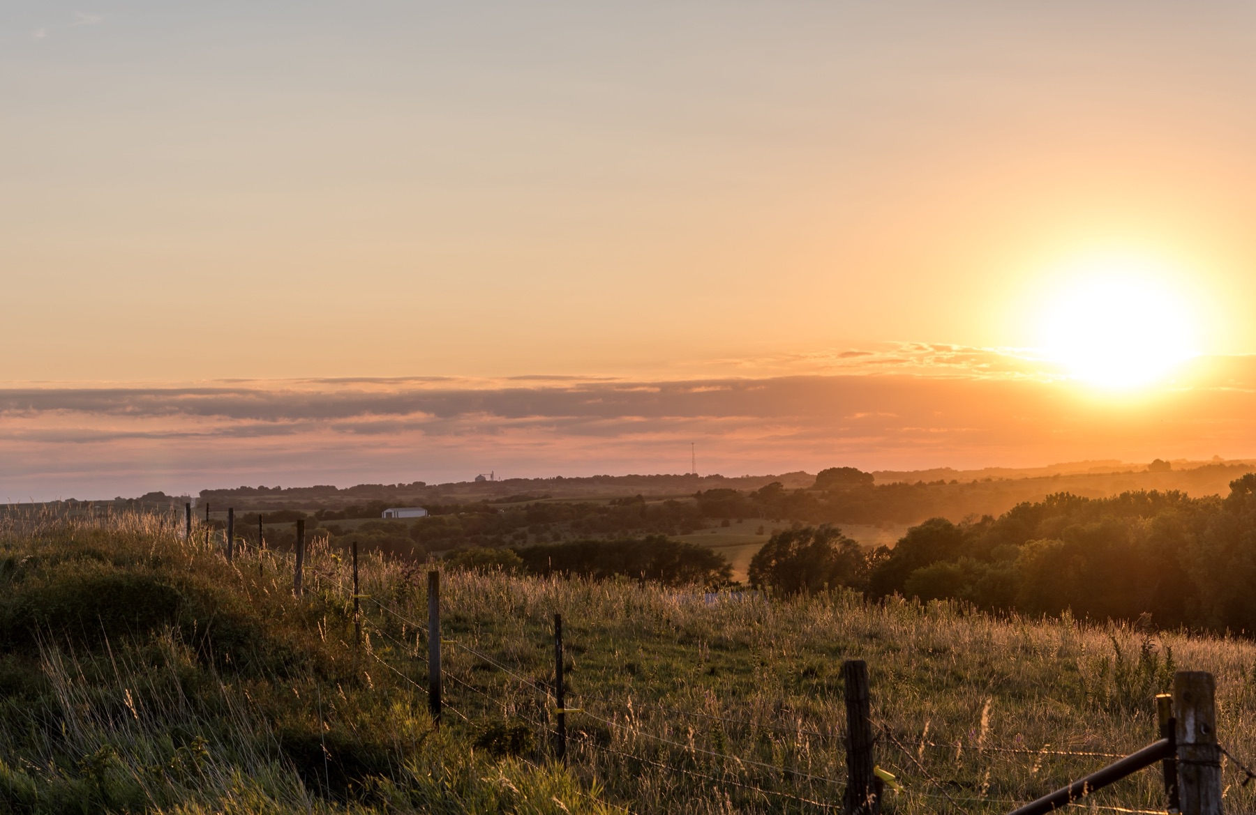 Sunrise over a Nebraska pasture fence line, Nebraska